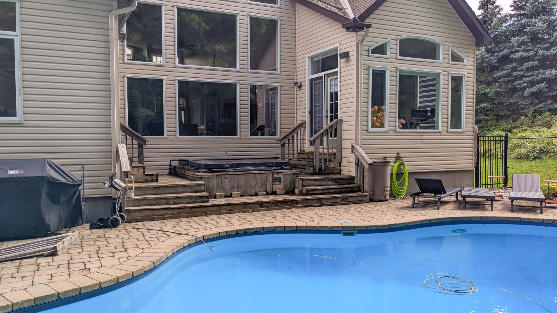 Original hot tub deck by the pool before the Barrhaven composite deck renovation