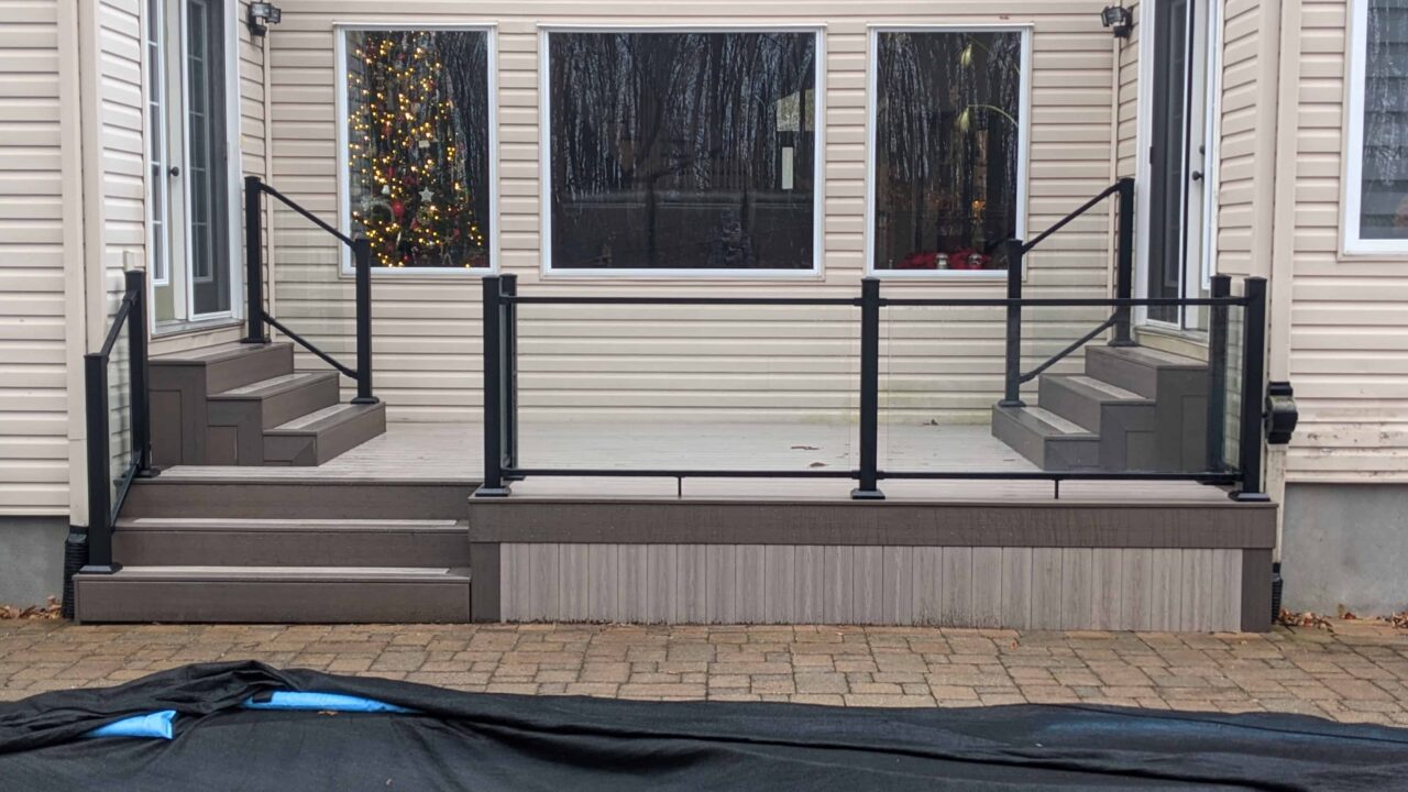 Finished Cabana Latte composite deck with Fortress glass railing in Barrhaven