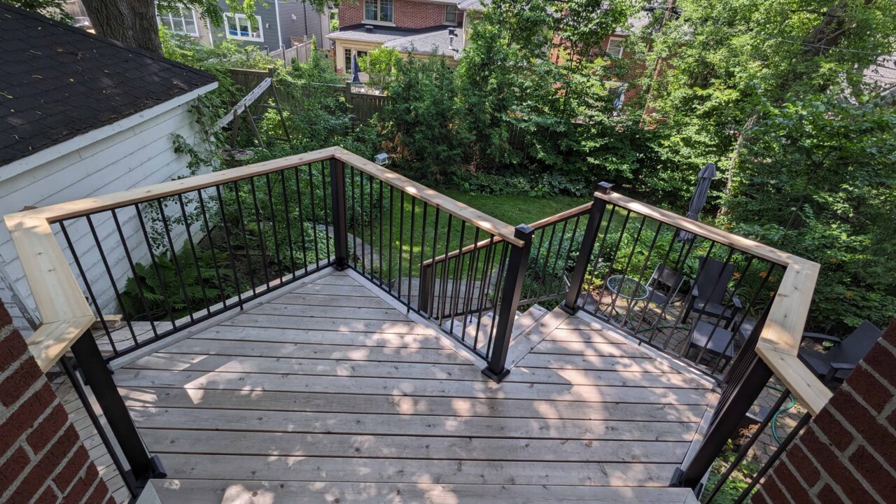 Deck detail with Fortress black rail and cedar drink rail center