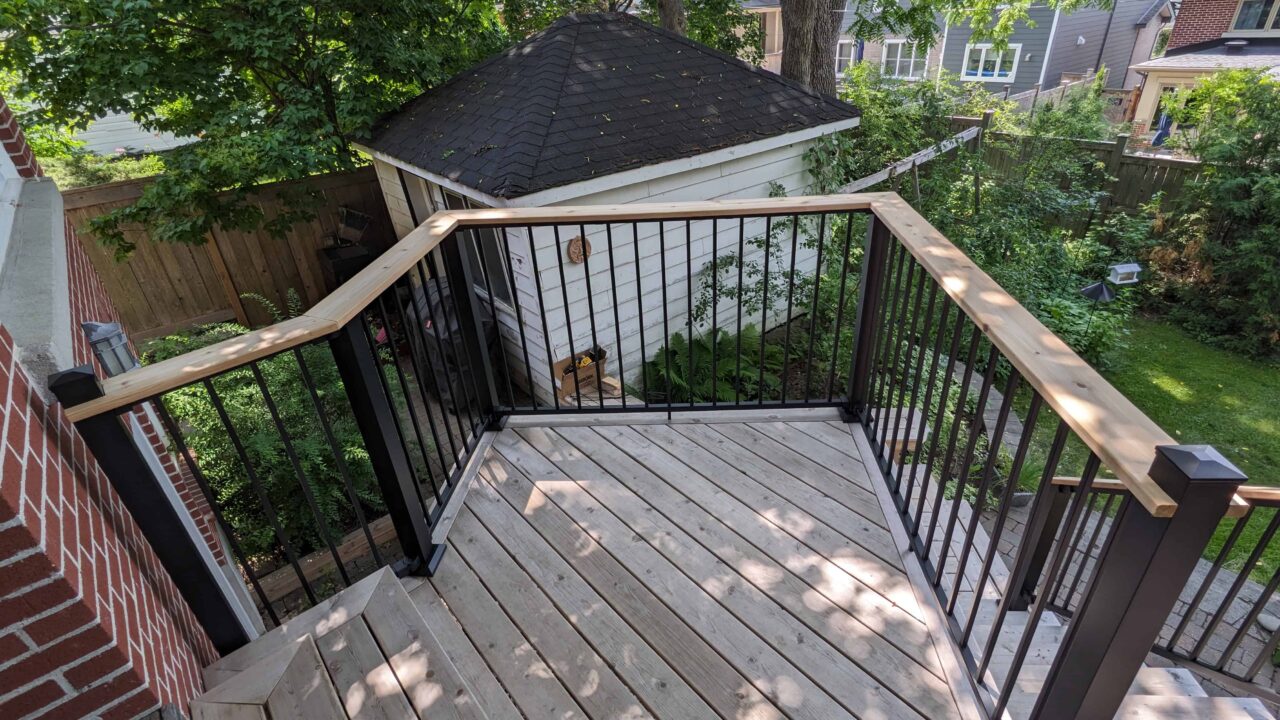 Deck detail with Fortress black rail and cedar drink rail left side