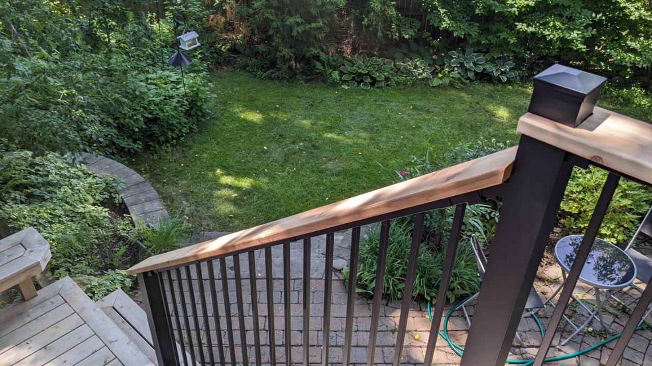 Staircase with Fortress black railing and cedar drink rail