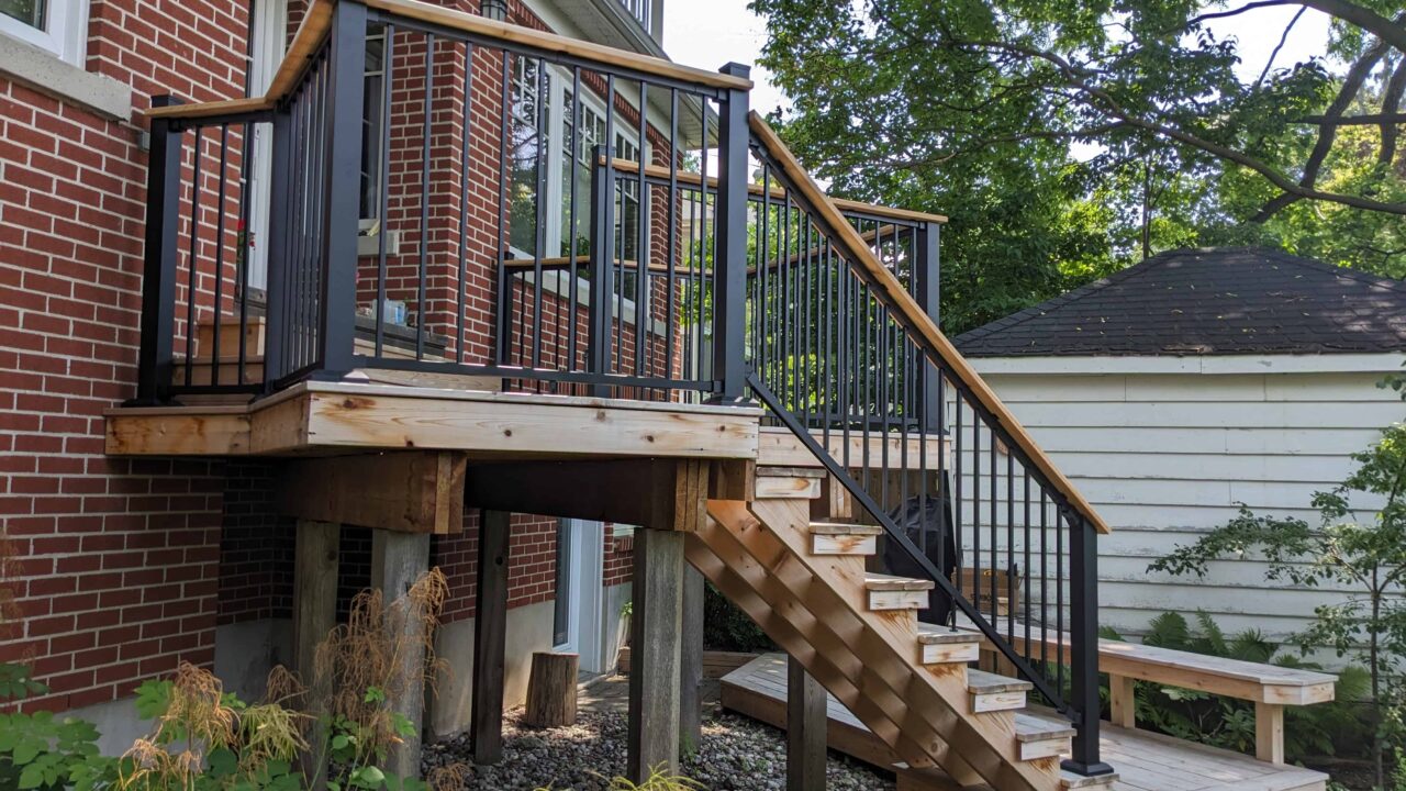 Finished Fortress black railing with cedar drink rail left view