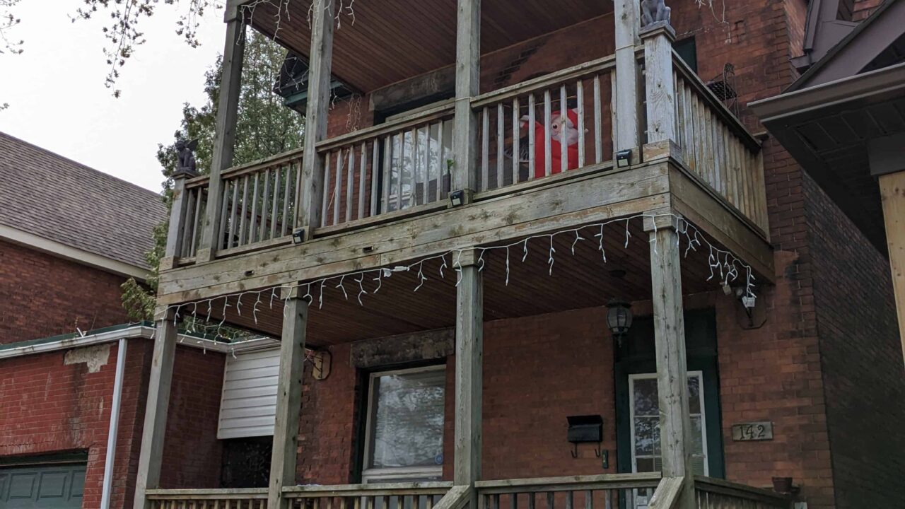 Old multi-level pressure-treated deck before teardown