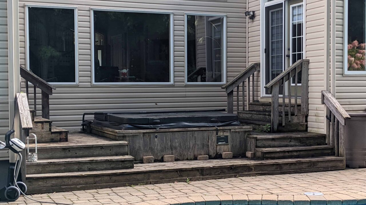 Old pressure-treated deck before poolside renovation in Barrhaven