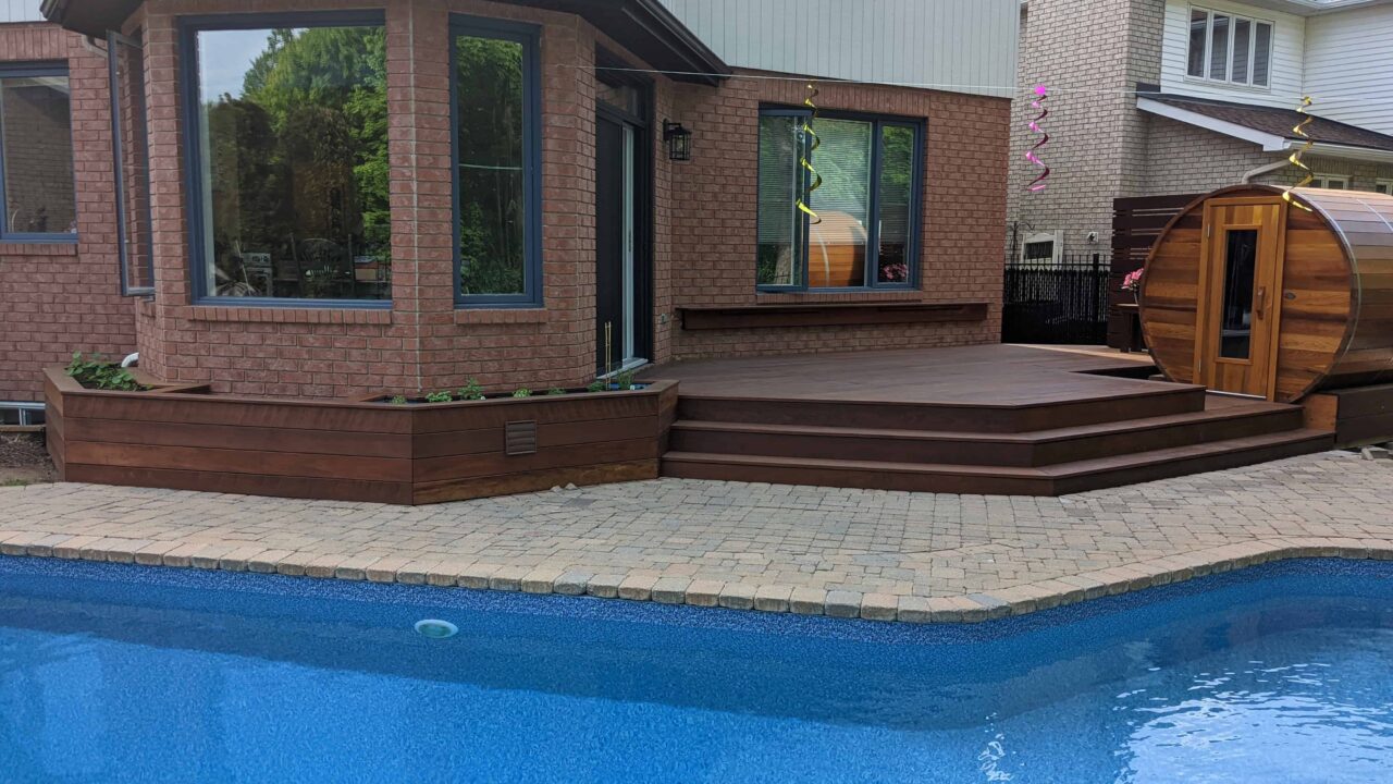 Oiled IPE poolside deck with integrated planters in Kanata