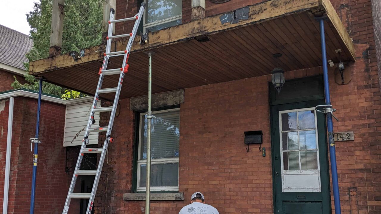 Old pressure-treated deck during teardown before replacement