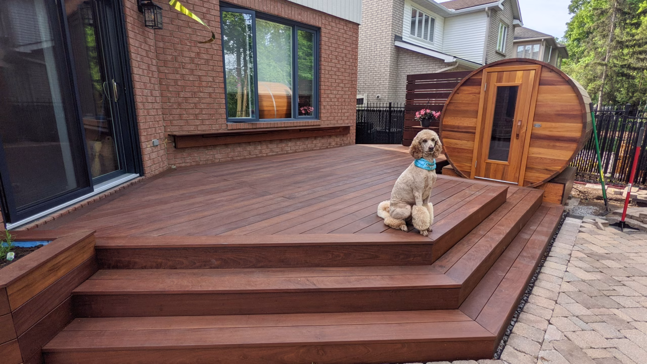Finished Ipe deck with planter boxes, privacy wall, and sauna-step platform in Kanata