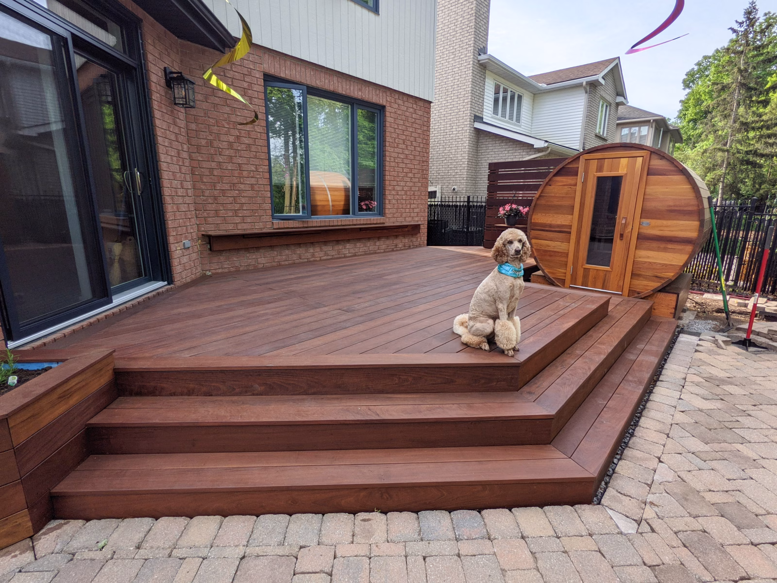 Finished Ipe deck with planter boxes, privacy wall, and sauna-step platform in Kanata